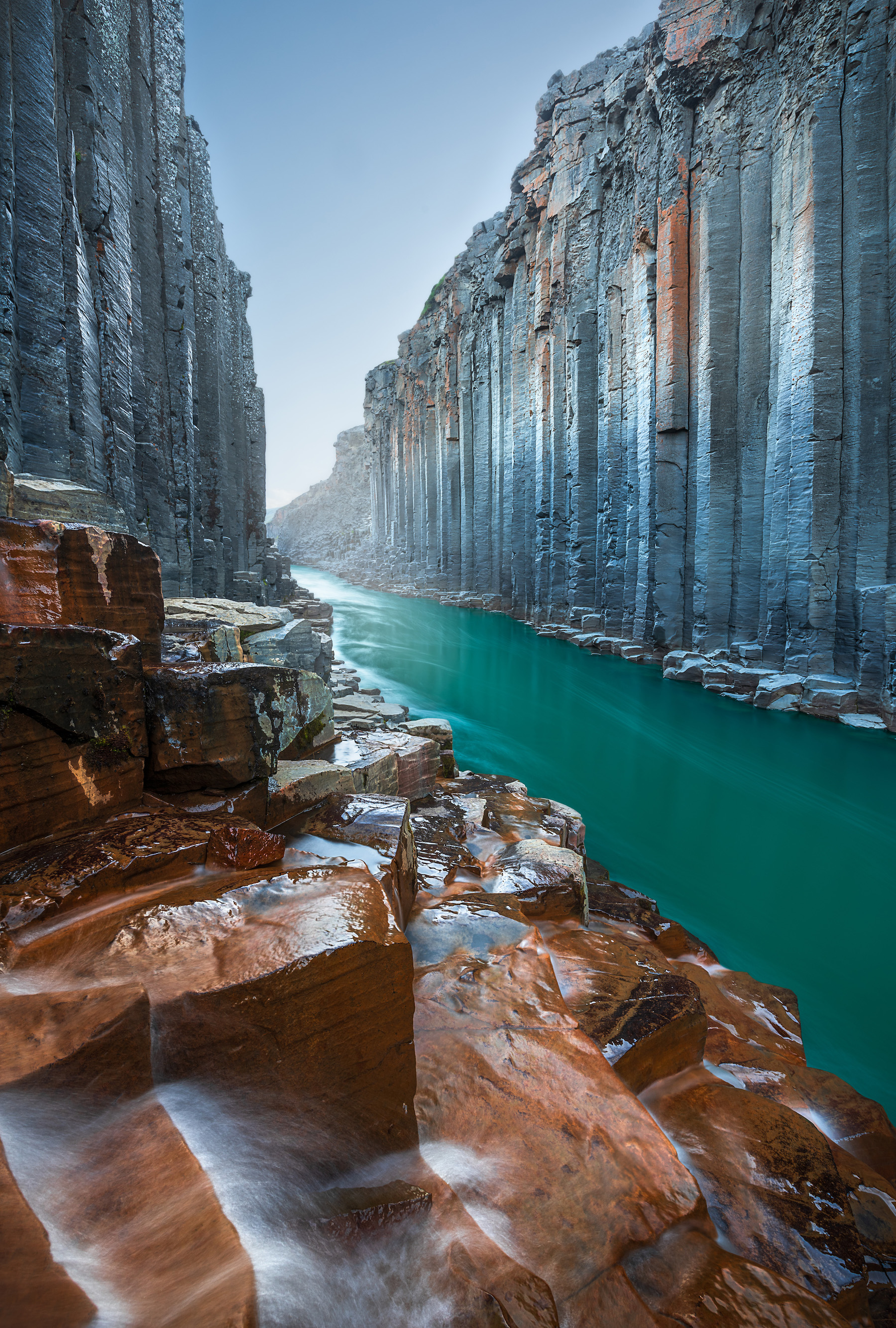 river flowing through steep rigged rocks