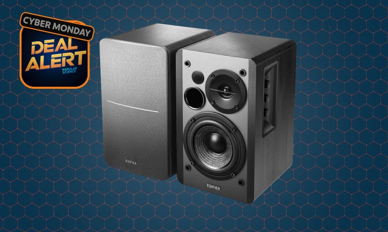 Black Edifier 1280DBs powered desktop speakers on a dark blue Cyber Monday background