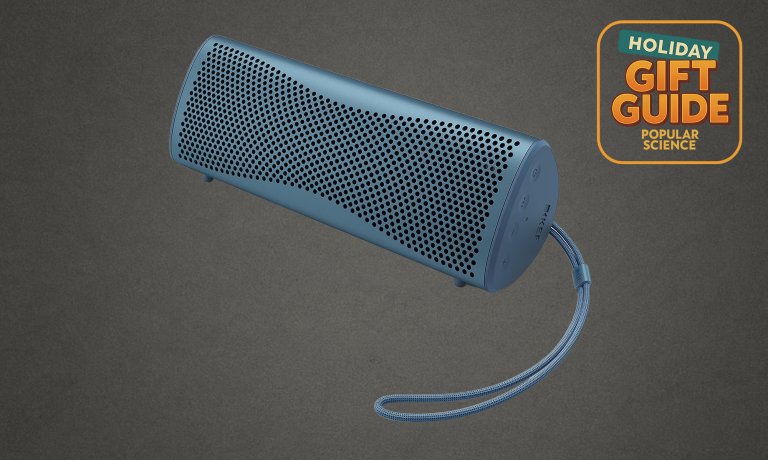 KEF Muo Portable Bluetooth Speaker in Blue Aura on a grey holiday gift guide background