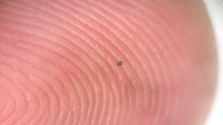 A salt grain-sized microrobot on a human finger to illustrate size