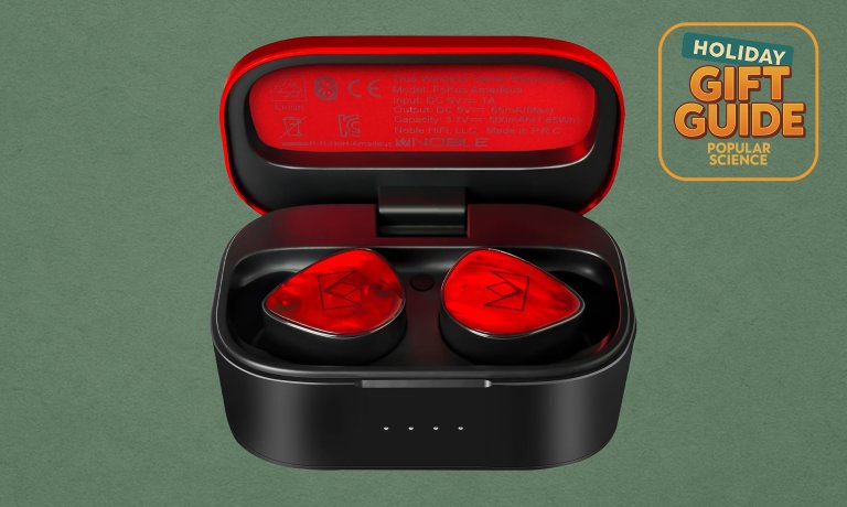 Red Noble Audio FoKus Amadeus true wireless earbuds on a green holiday background
