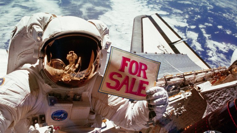 An astronaut in a white spacesuit floats in space above Earth, holding a handmade sign that reads “FOR SALE” in large pink letters. Reflections of space equipment and Earth are visible in the astronaut’s helmet visor, and part of a space shuttle is seen behind them with the blue curve of Earth in the background.