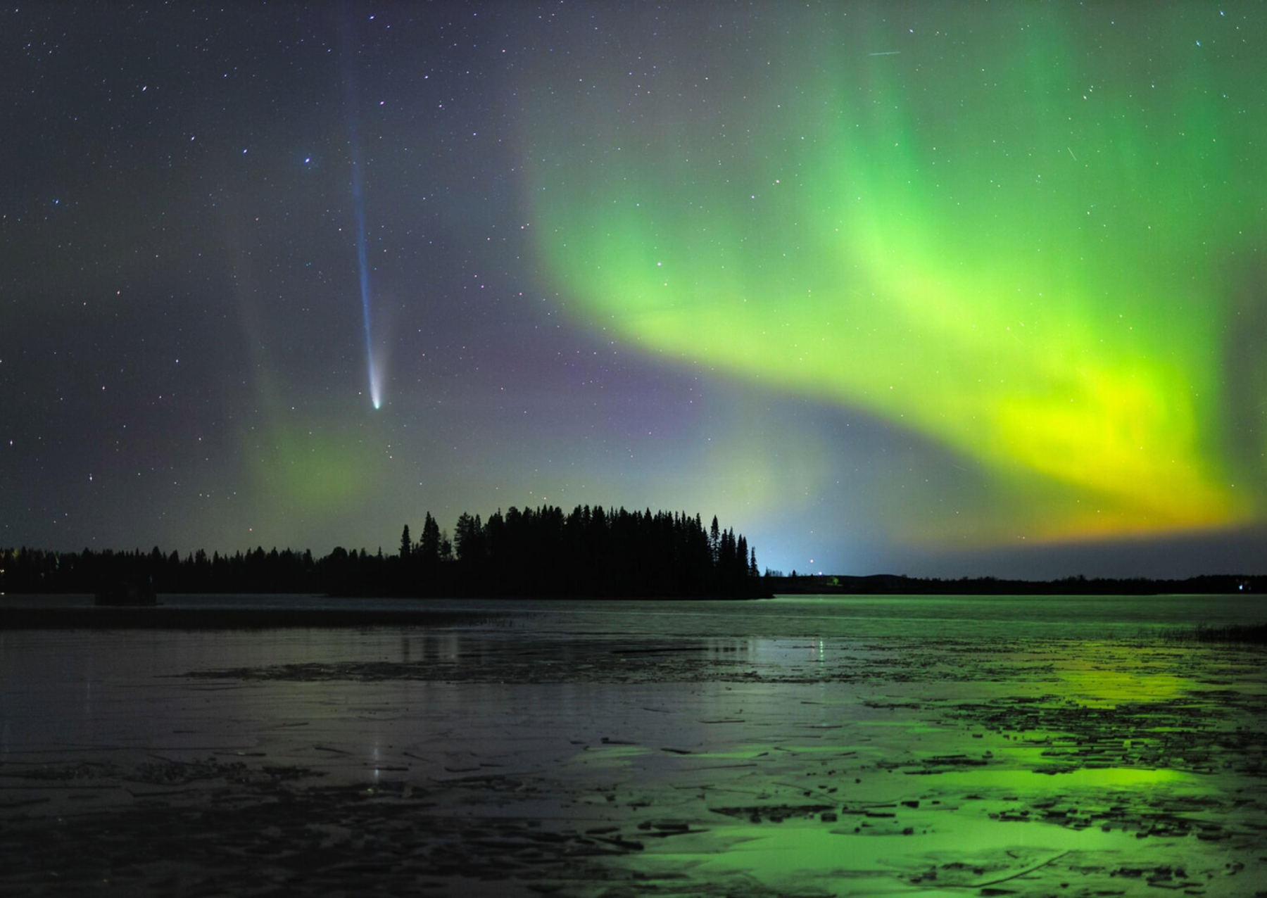 a comet whizzing by a green aurora