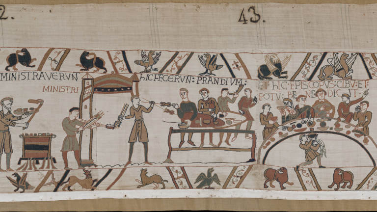 A scene from the Bayeux Tapestry showing a medieval dining scene involving Bishop Odo of Bayeux.