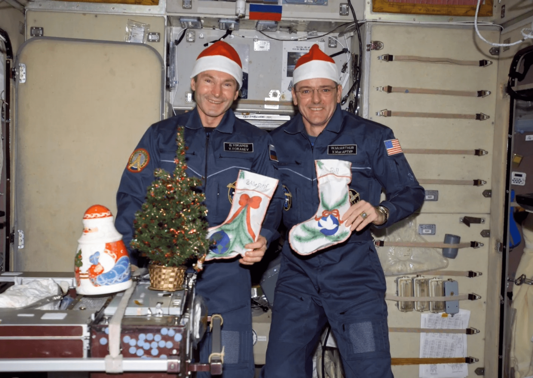 two astronauts posing with christmas stockings