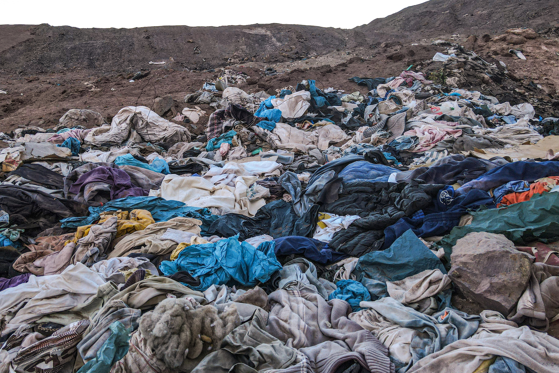ALTO HOSPICIO, CHILE - JUNE 15: A view of waste fabric pieces or clothes in Atacama Desert, the world's driest and hottest desert, in Alto Hospicio, Chile on June 15, 2023. The La Pampa region, 20 km from the port city of Iquique on the Pacific coast, is threatened with environmental pollution due to thousands of tons of plastic waste, garbage textiles and rubble piles. (Photo by Lucas Aguayo Araos/Anadolu Agency via Getty Images)