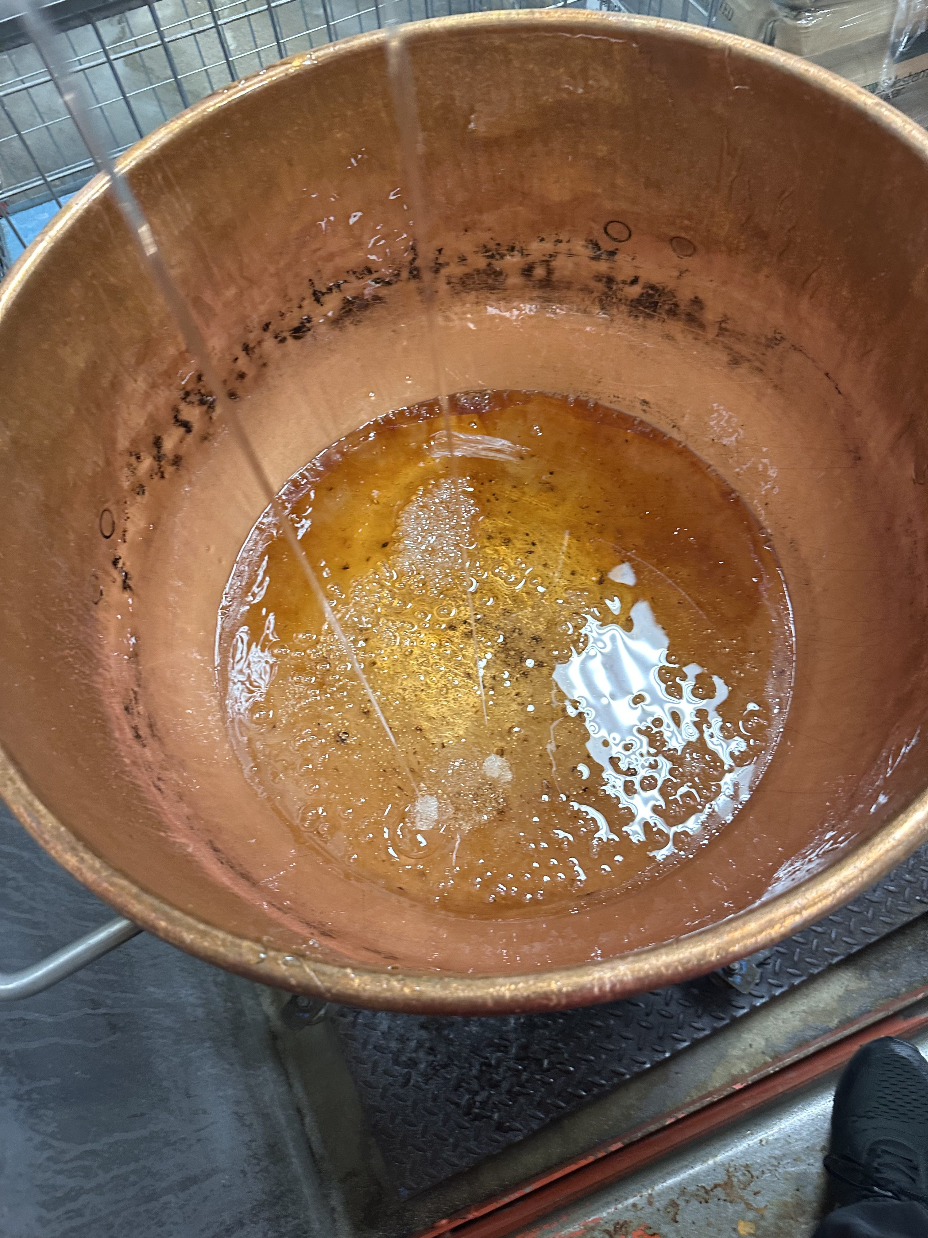 liquified sugar in a copper bowl