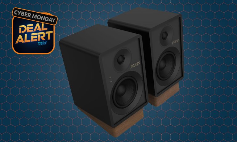 Black Onkyo Creator Series powered desktop speakers on a dark blue Cyber Monday background