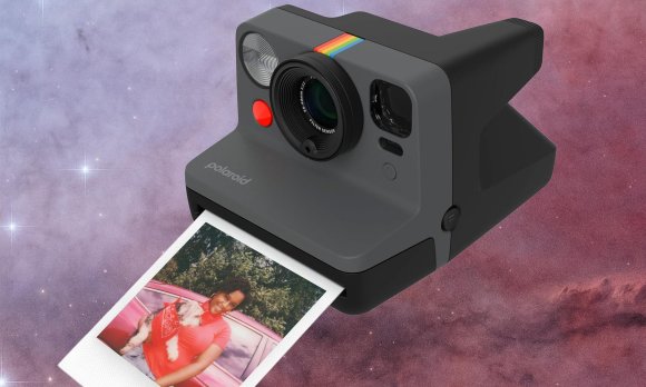 Polaroid I-Type camera with a print coming out