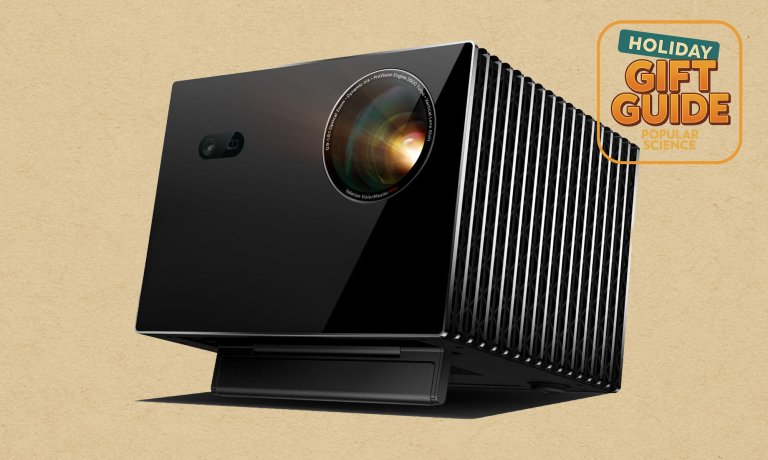 Black and chrome Valerion VisionMaster Max lifestyle projector on a beige holiday gift guide background