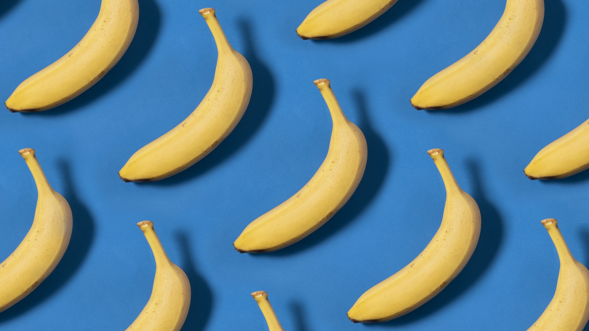Yellow bananas arranged against a blue background