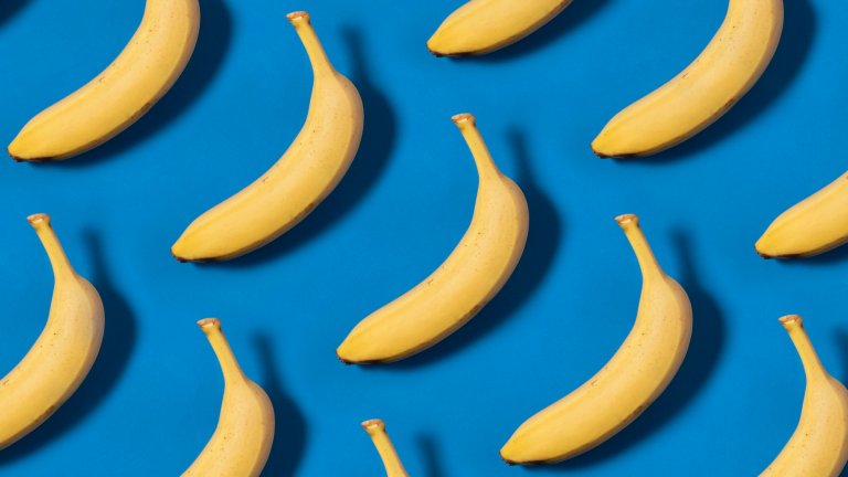 Yellow bananas arranged against a blue background