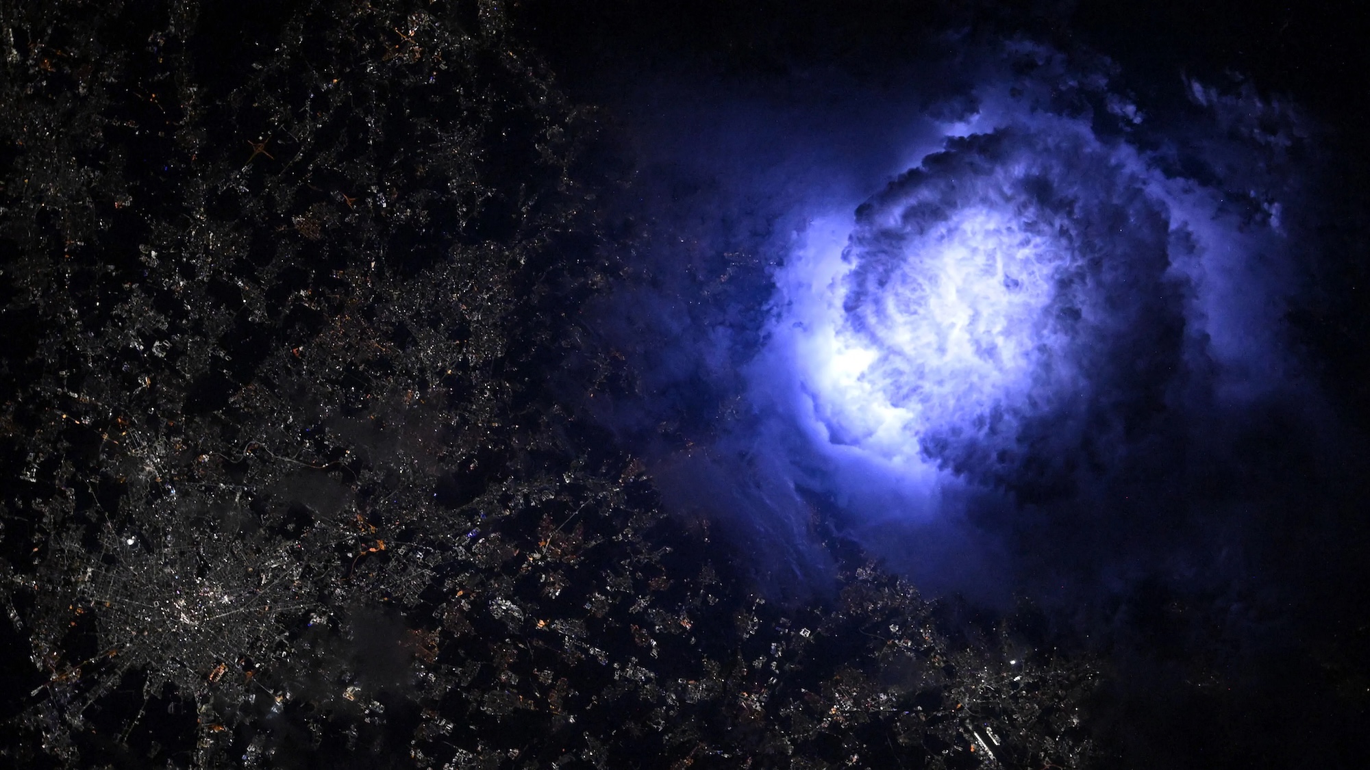 Photograph of lightning inside storm cloud taken above Milan, Italy, at night aboard the ISS