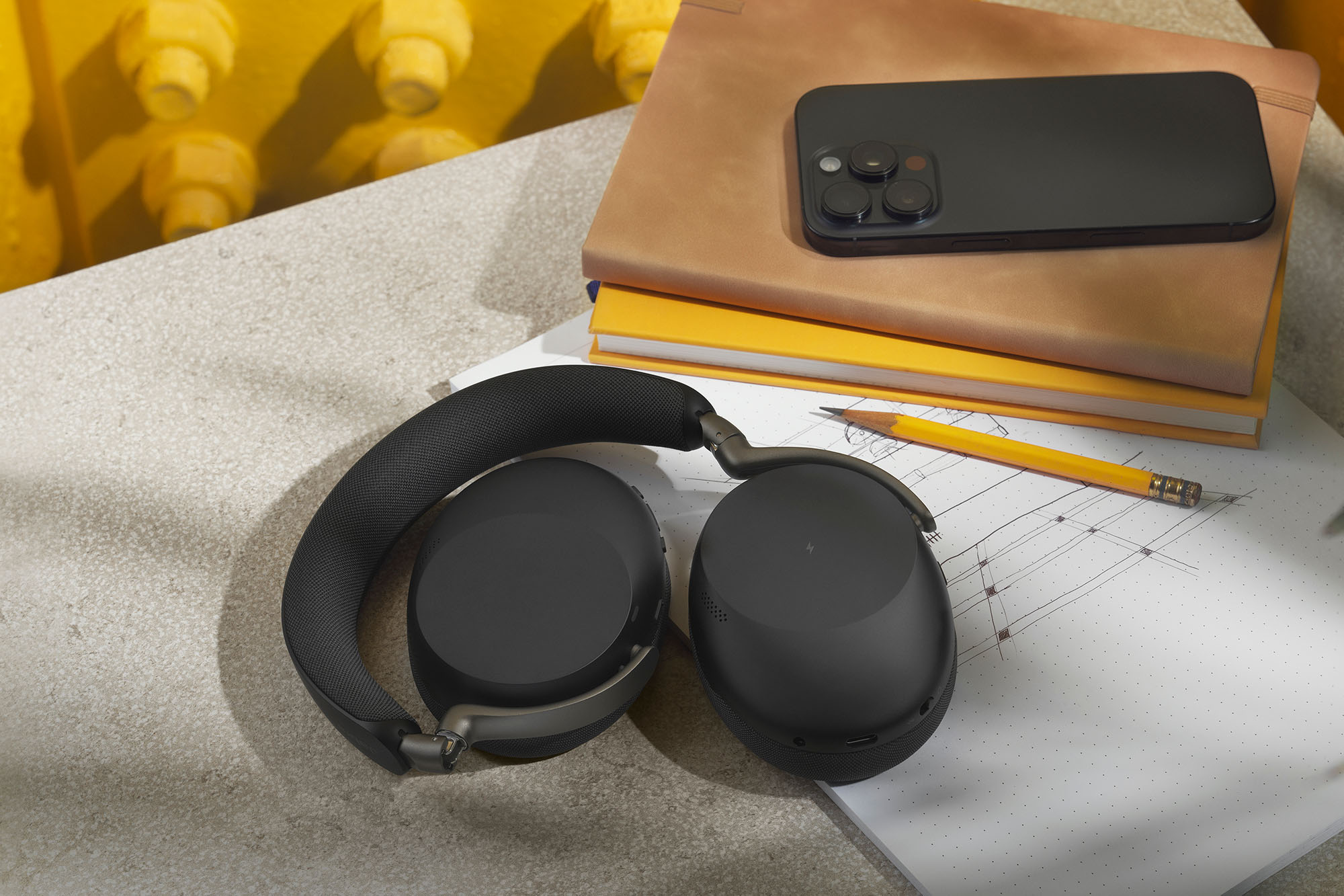 A black Jabra Evolve3 85 headset folded on a desk