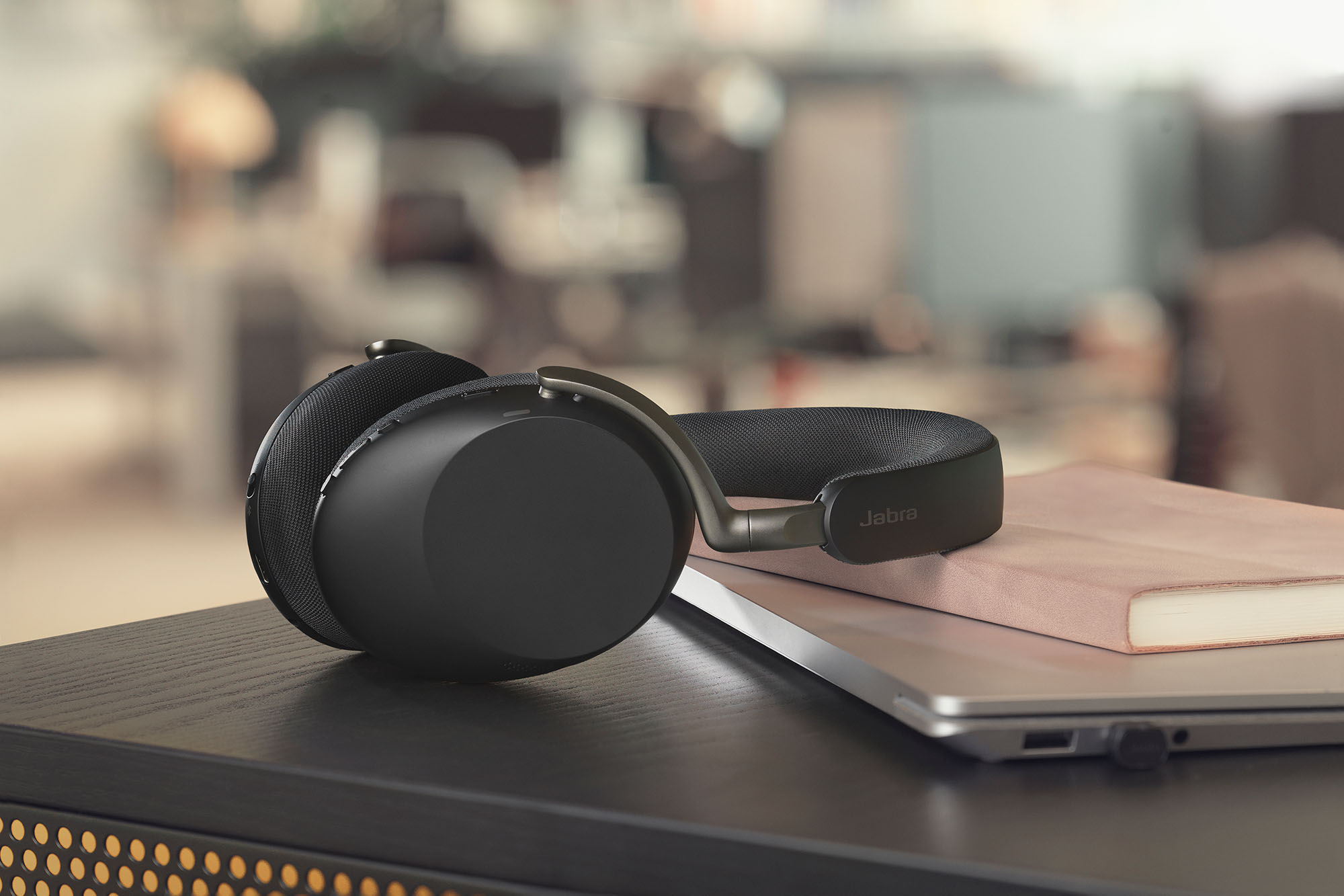 A black Jabra Evolve3 85 headset sitting on a desk
