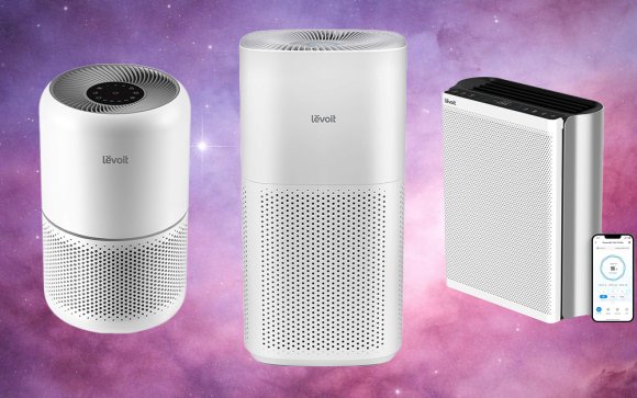 Three models of white LEVOIT air purifiers against a purplish solar background