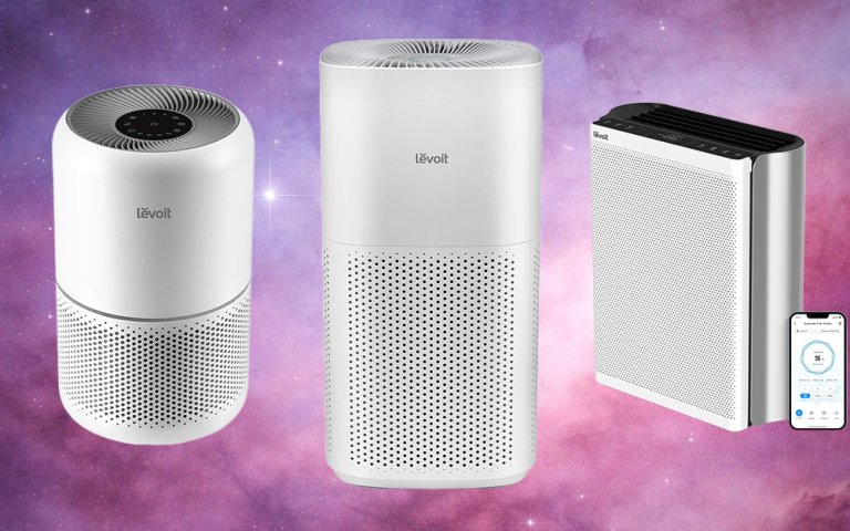 Three models of white LEVOIT air purifiers against a purplish solar background