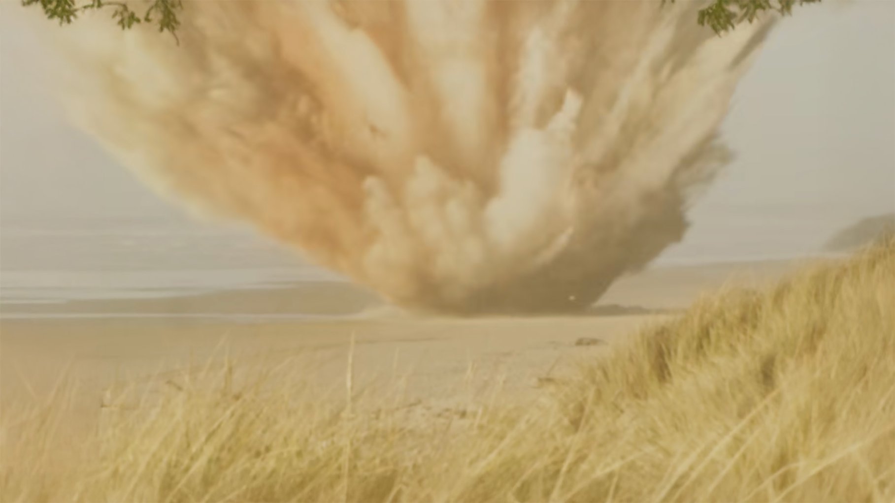 A vintage photograph of an explosion happening on a baech.