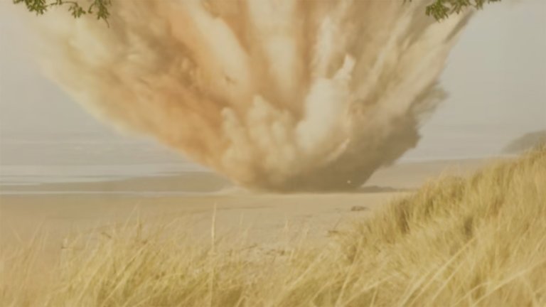 A vintage photograph of an explosion happening on a baech.