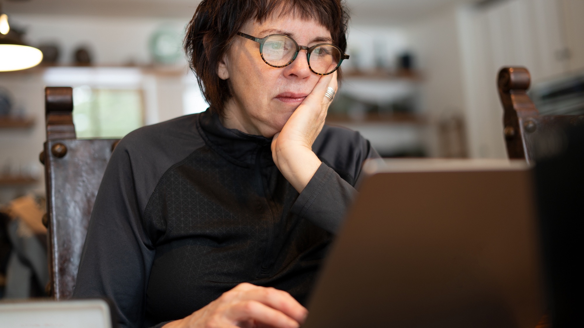 January 4, 2022 Deerton, MI Mature woman working on laptop in her home.