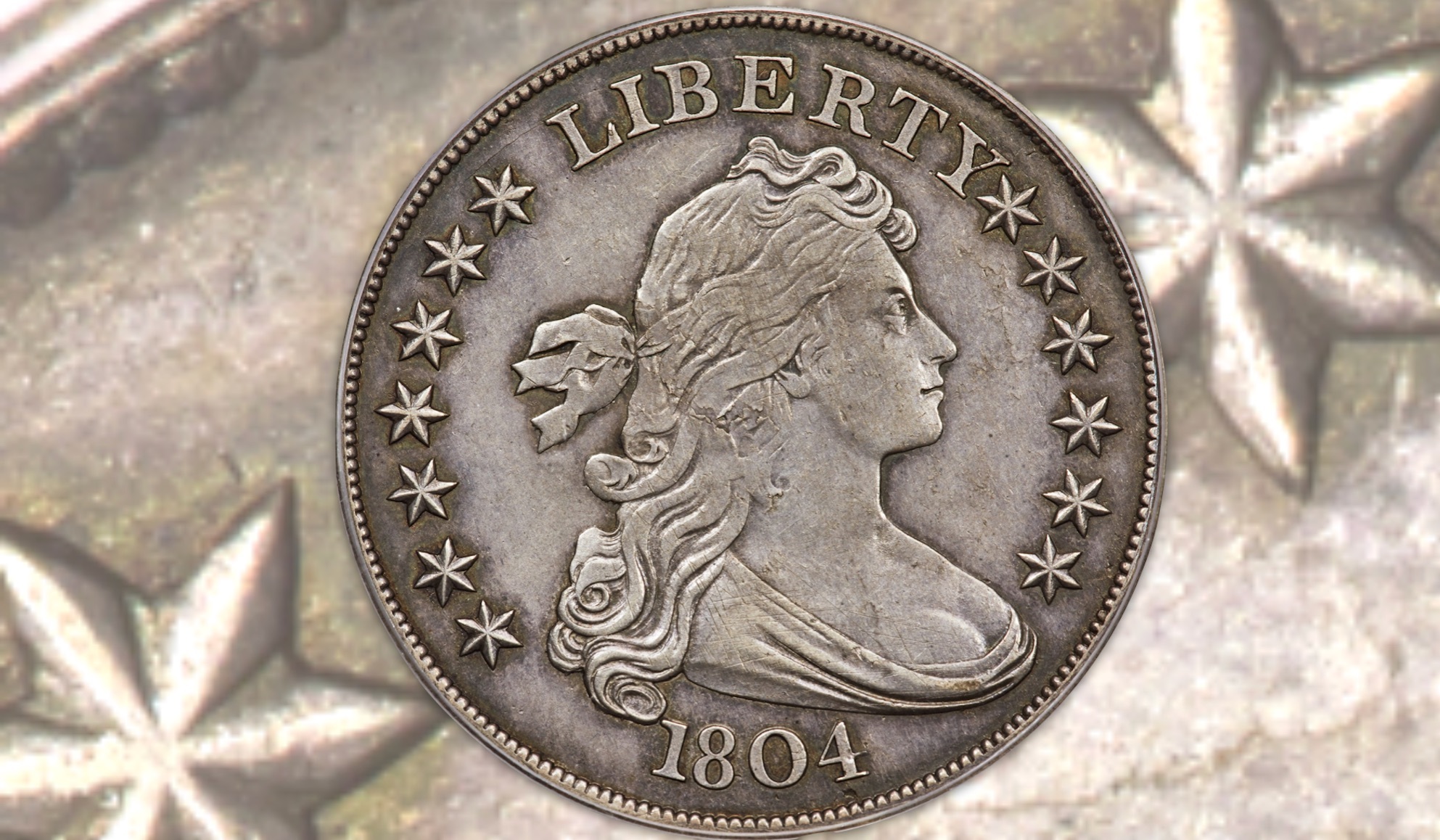 a coin minted in 1804. it is silver and features the word liberty, the profile of a woman with long hair, and the year 1804