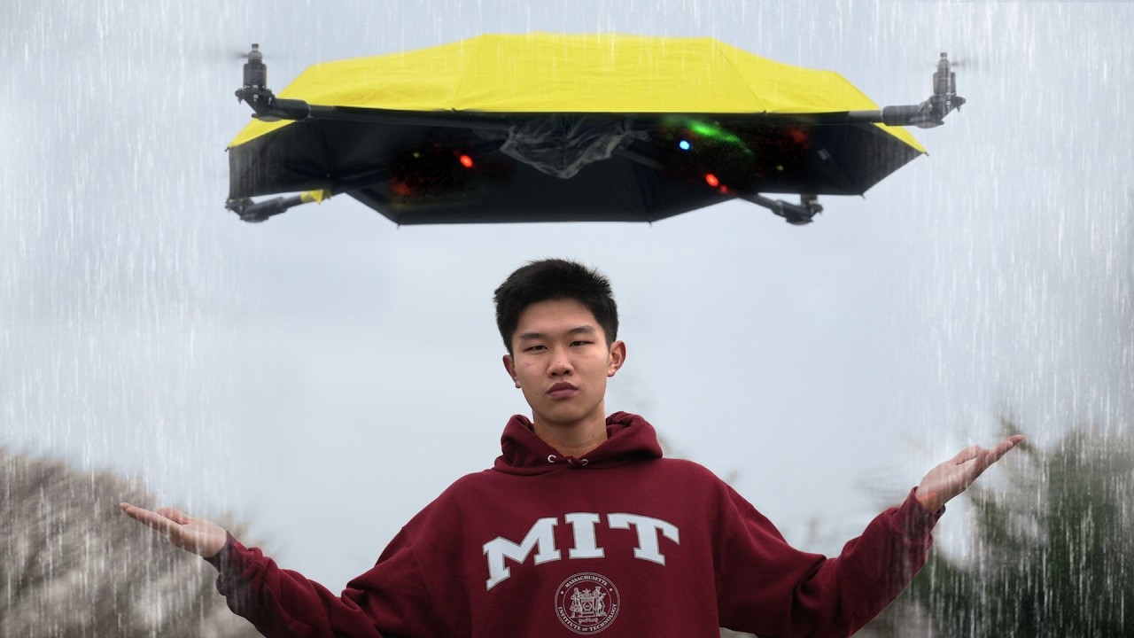 man standing under drone umbrella in the rain