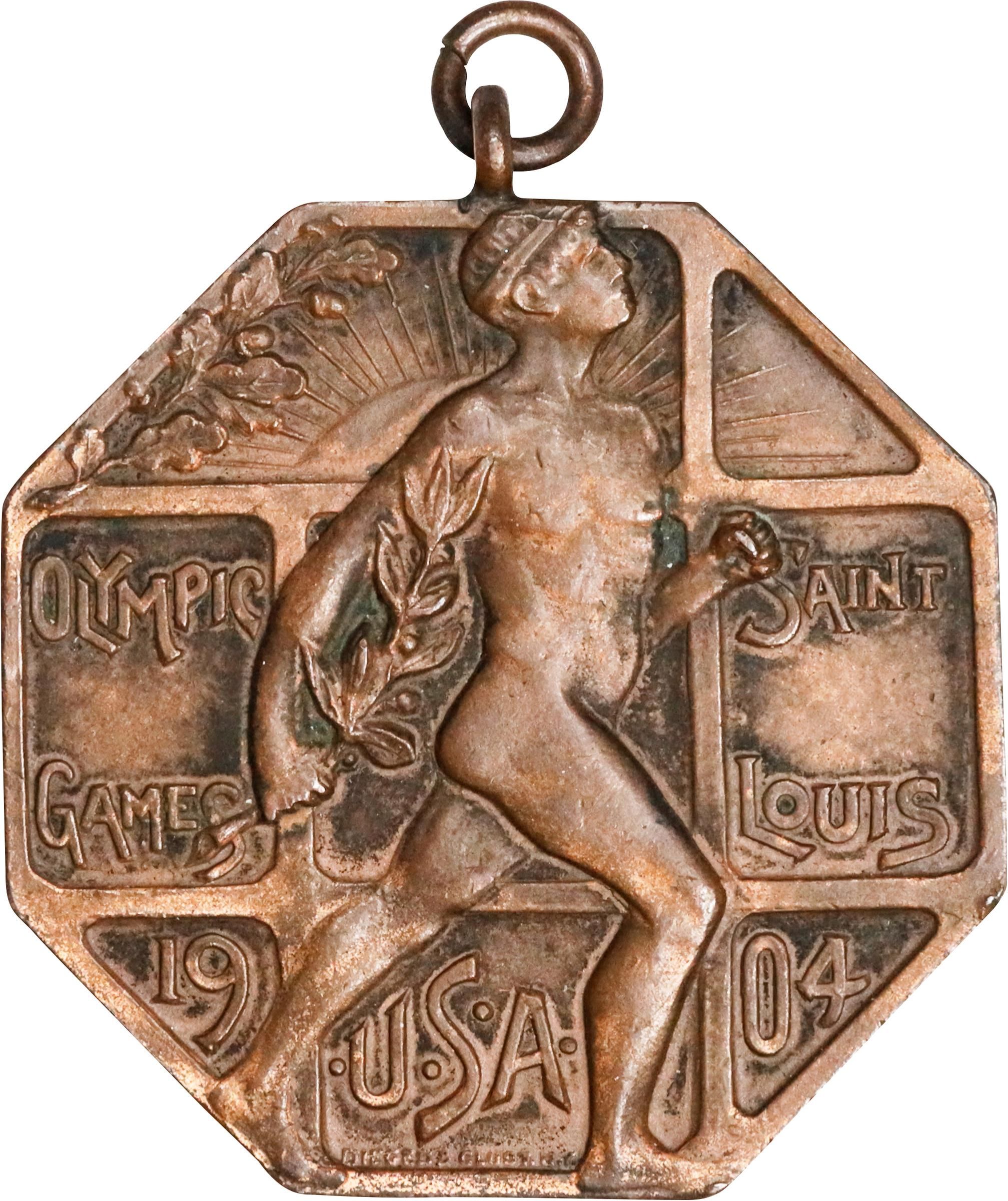 a bronze medal showing a runner from the 1904 olympics