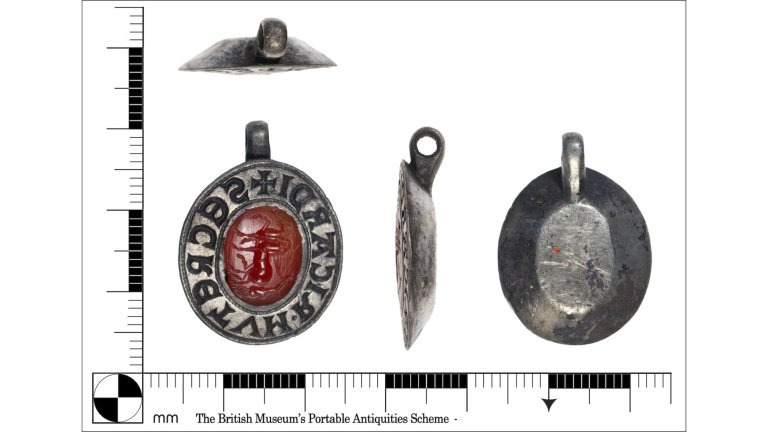 Various angles of silver pendant with Roman gem inlay next to measurement references