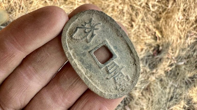19th century Japanese coin in metal detectorist's hand