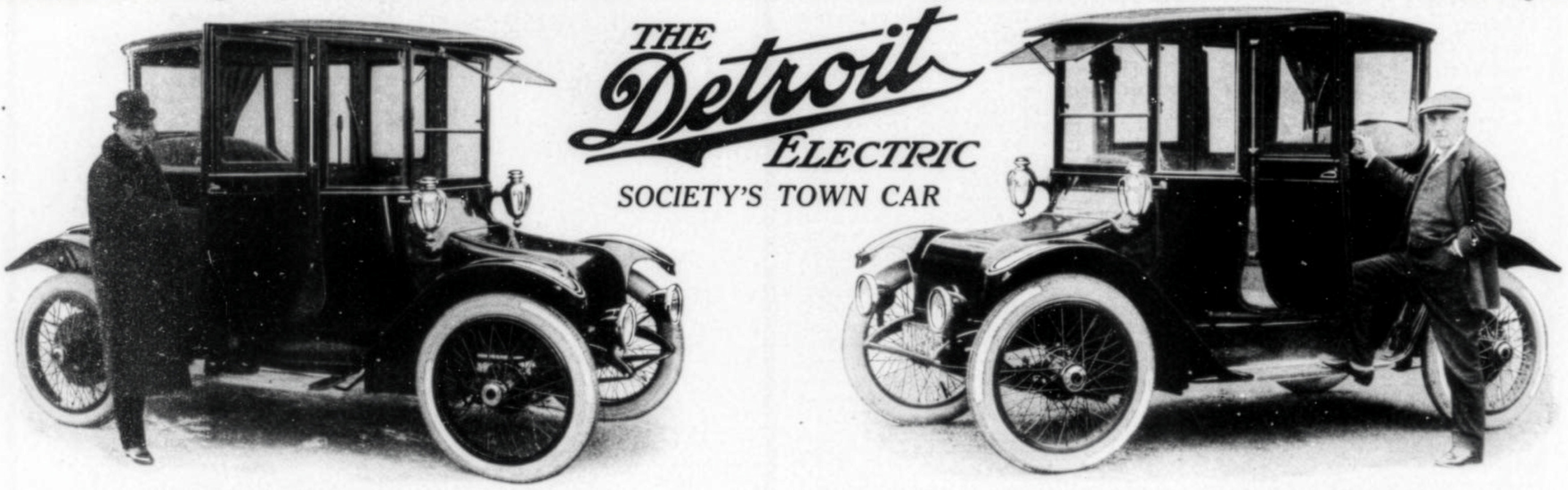 A vintage, black-and-white promotional advertisement for The Detroit Electric car, featuring two of history's most famous innovators.

The image shows a split composition:

On the left: Henry Ford stands beside a dark, high-roofed Detroit Electric vehicle.

On the right: Thomas Edison poses with one foot on the running board of a matching car.

In the center: The stylized cursive logo for "The Detroit Electric" is displayed above the slogan, "SOCIETY'S TOWN CAR."

Both men are dressed in early 20th-century formal attire, emphasizing the vehicle's branding as a sophisticated and reliable choice for the era's elite.