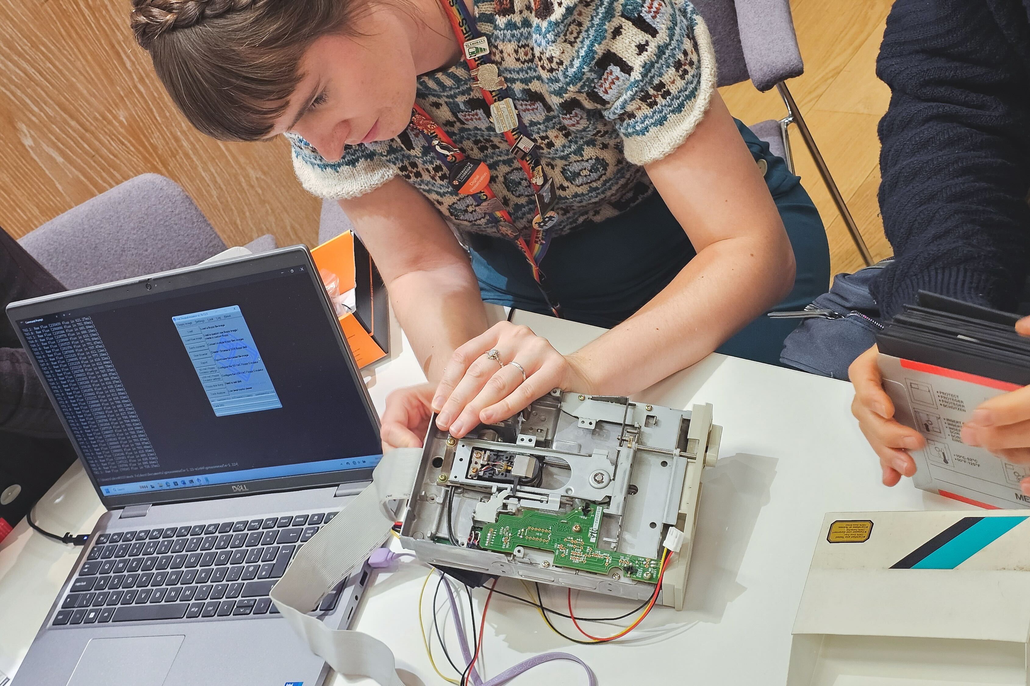 a woman works on a floppy disk drive