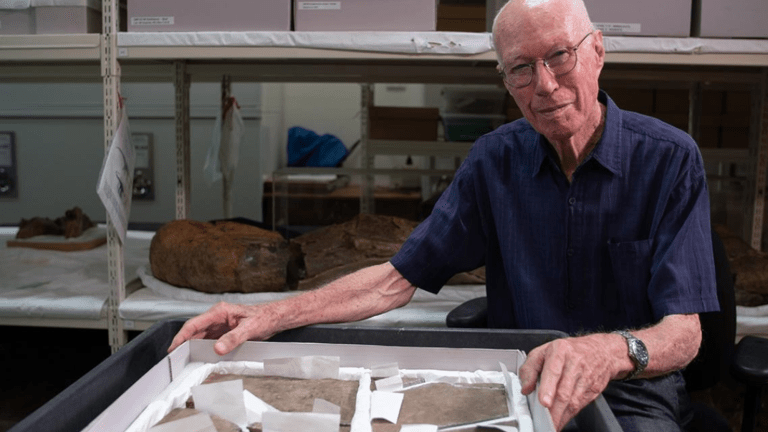 a man hold a dinosaur footprint in a lab