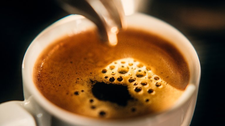 Cup of fresh espresso out of a espresso machine.