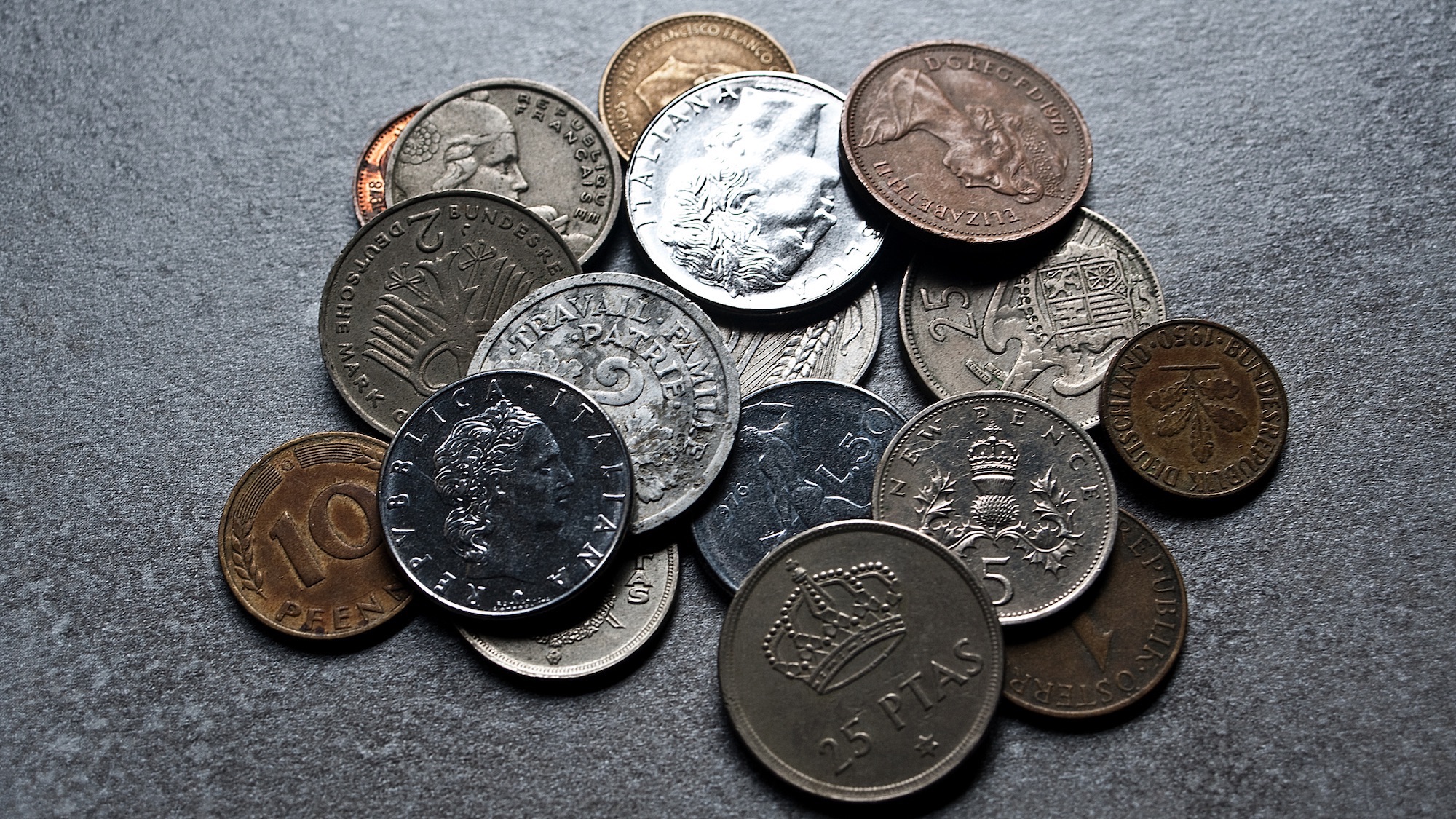 Old coins from Spain, United Kingdom, France, Italy, Federal Republic of Germany and Austria. These coins are dating from the 1950s, 1960s, 1970s and 1980s.