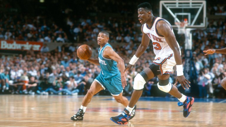 Muggsy Bogues #1 of the Charlotte Hornets looks to pass the ball past Patrick Ewing #33 of the New York Knicks during an NBA basketball game circa 1993 at Madison Square Garden in the Manhattan borough of New York City.