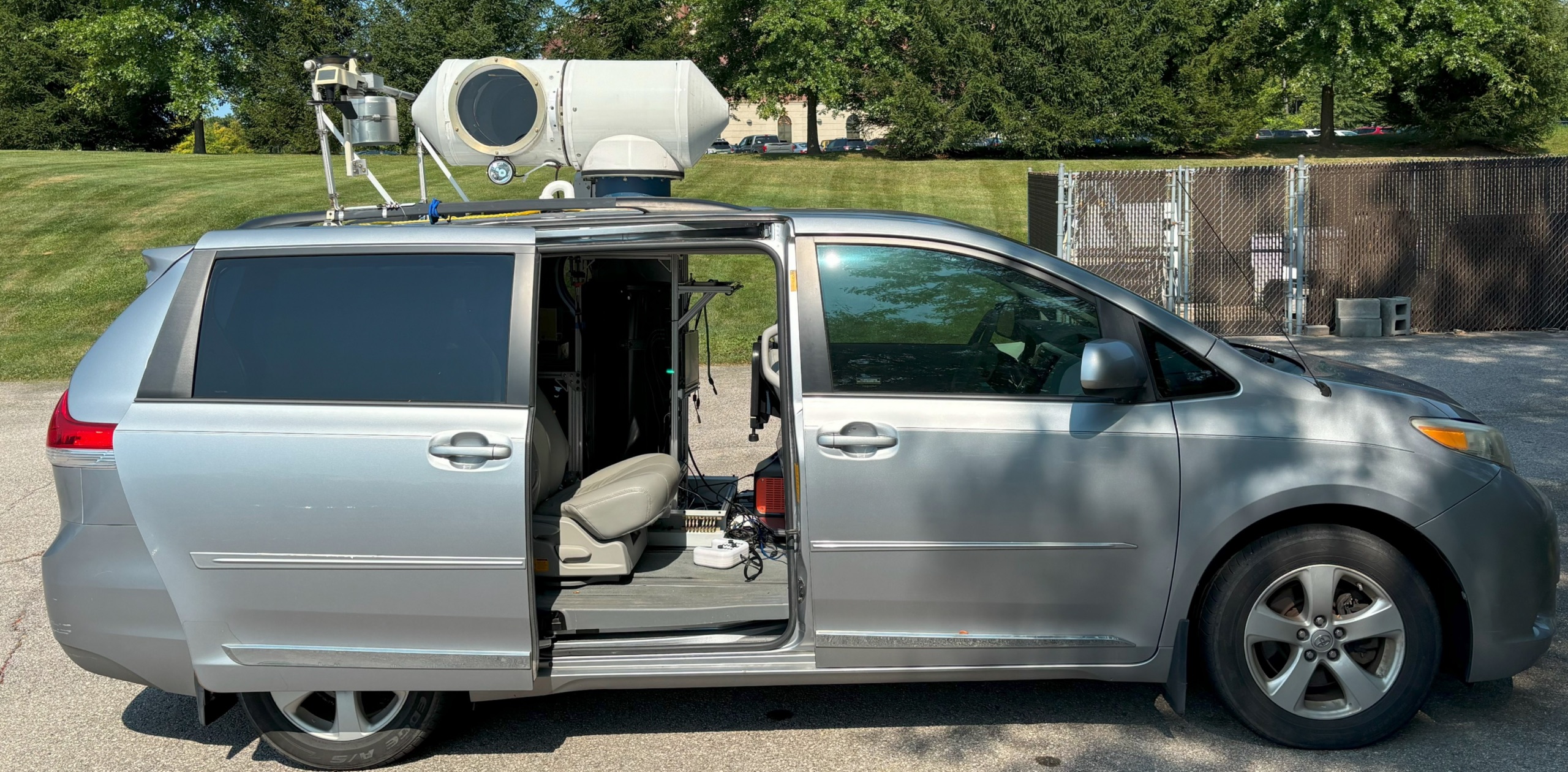 a gray minivan with weather radar on top