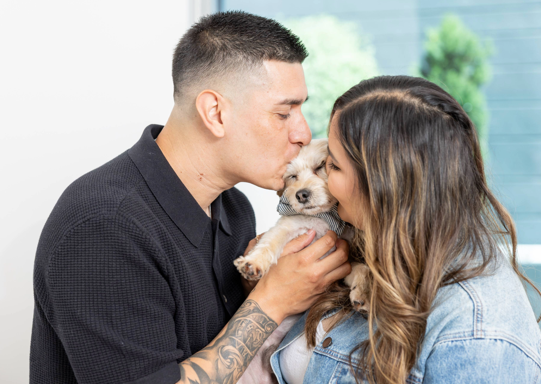 a man and a woman hugging their dog