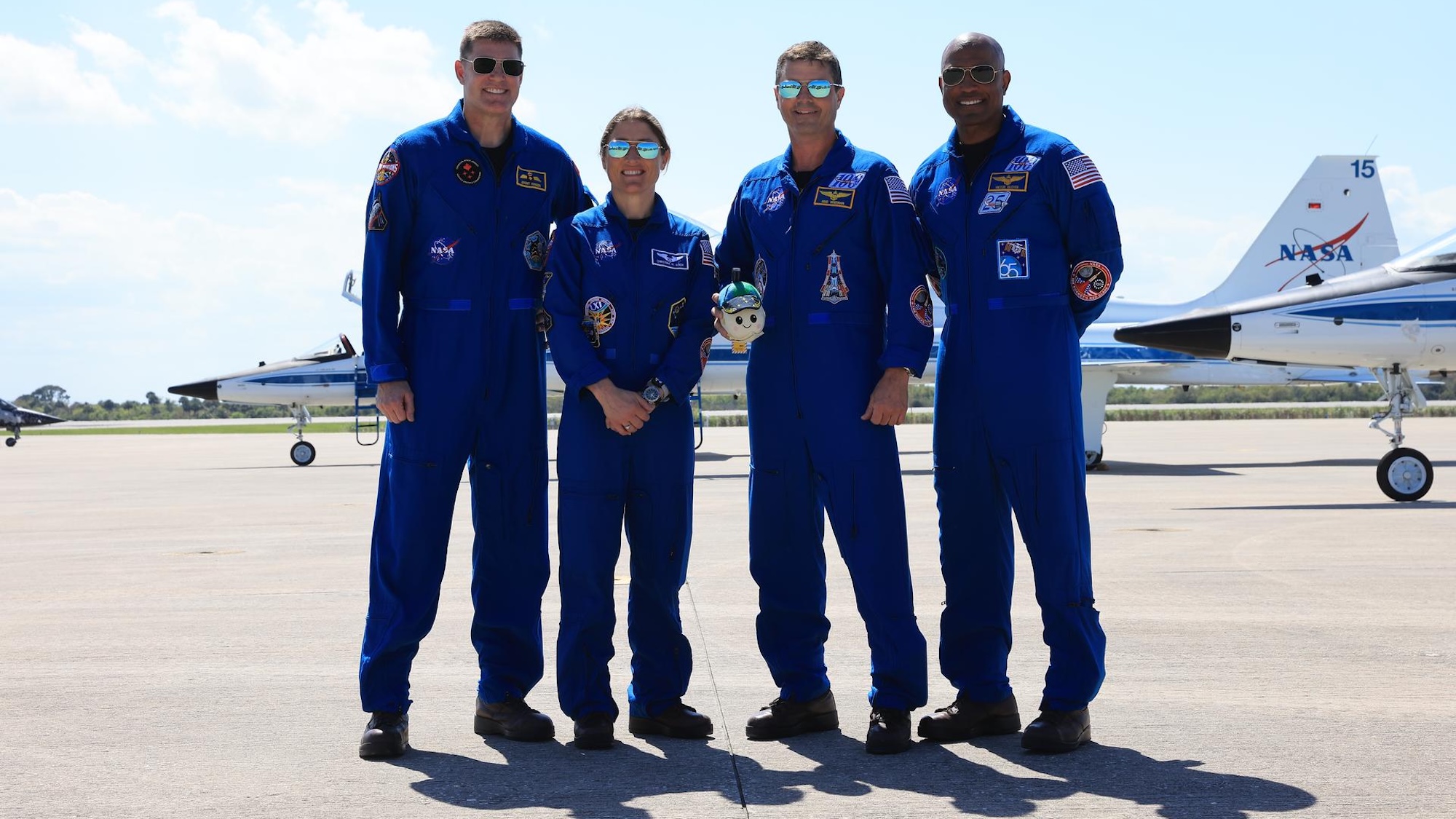 From left to right, Artemis II Mission Specialist Jeremy Hansen from CSA (Canadian Space Agency), Mission Specialist Christina Koch, Commander Reid Wiseman, and Pilot Victor Glover, arrive on Friday, March 27, 2026, at the Launch and Landing Facility at the agency’s Kennedy Space Center in Florida in preparation for the Artemis II test flight.