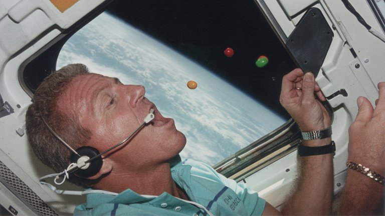 Astronaut Loren J. Shriver, Mission Commander of STS-46, attempts to eat floating sweets on the flight deck of the shuttle Atlantis during its orbit of the earth, August 1992. (Photo by Space Frontiers/Getty Images)