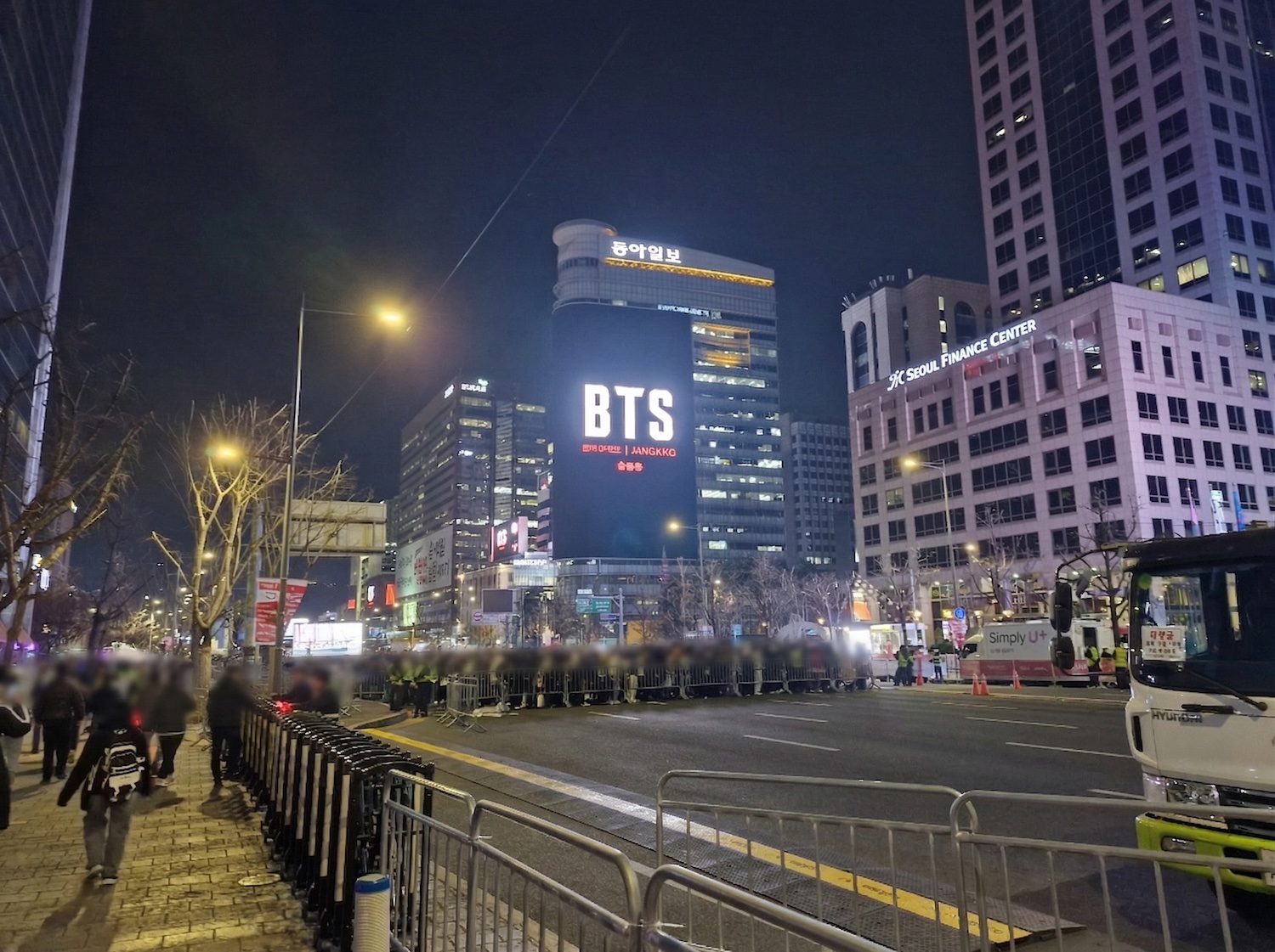 a street under a large screen