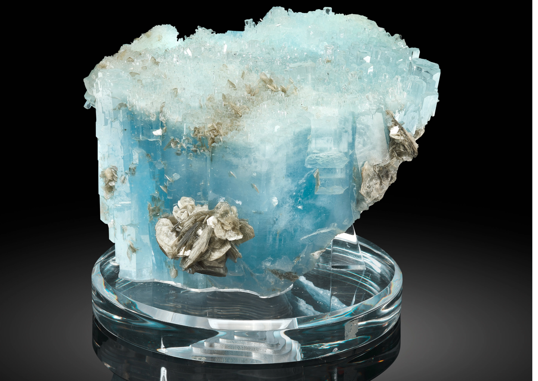 an aquamarine mineral on a black backgroun