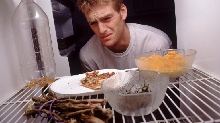 Man disappointed in what he sees in his refrigerator