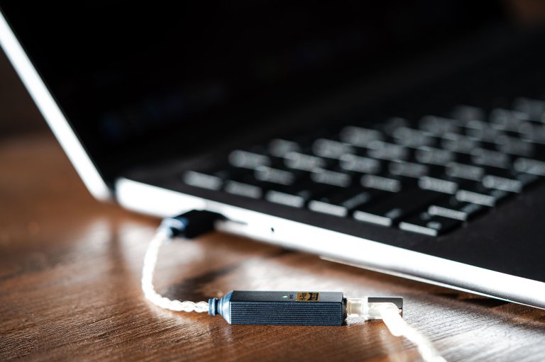 A USB-C iFi GO link 2 dongle DAC attached to a laptop