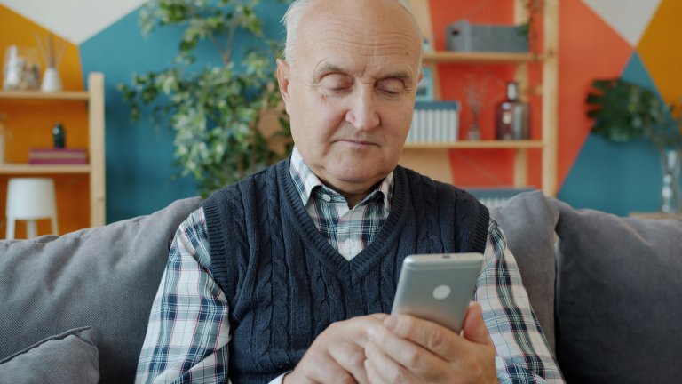 older man uses iphone