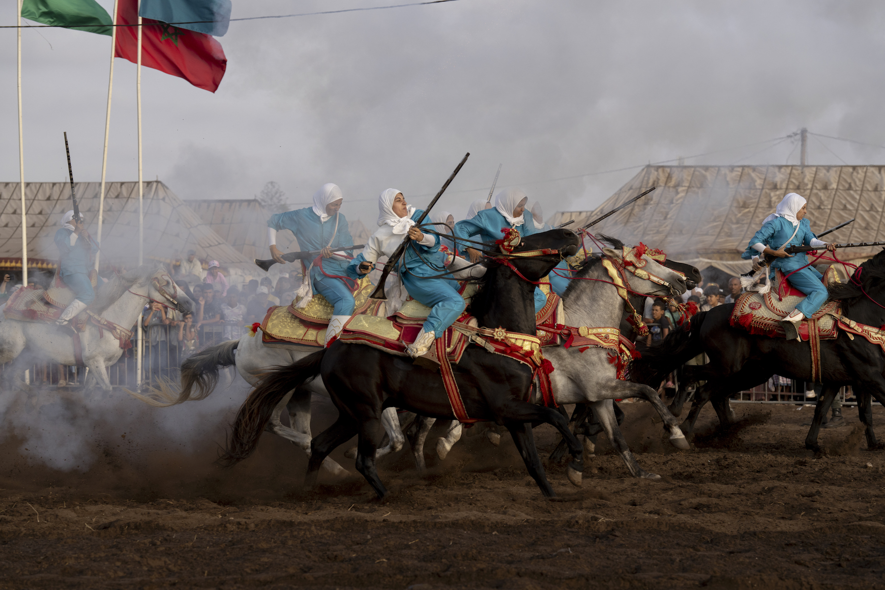 Title: Farīsāt: Gunpowder’s Daughters Credit: © Chantal Pinzi, Panos Pictures Caption: Noura attempts to control her horse after firing, the most dangerous part of the performance. Riders risk injury from gunpowder or falling and being trampled. Sidi Rahal, Morocco, 8 August 2025. Story: Tbourida is a UNESCO-recognized Moroccan equestrian tradition dating back to the 16th century. Troupes gallop in unison, firing rifles in a choreographed performance of cavalry warfare. Historically excluded, female riders have fought for inclusion since Morocco’s 2004 family code reforms strengthened women’s legal rights. Today, seven all-female troupes now ride among some 300. These farīsāt (horsewomen) bear significant personal costs, funding their own horses, costumes, and gunpowder permits. Their perseverance stands as a powerful claim to women’s rightful place in Moroccan cultural heritage.