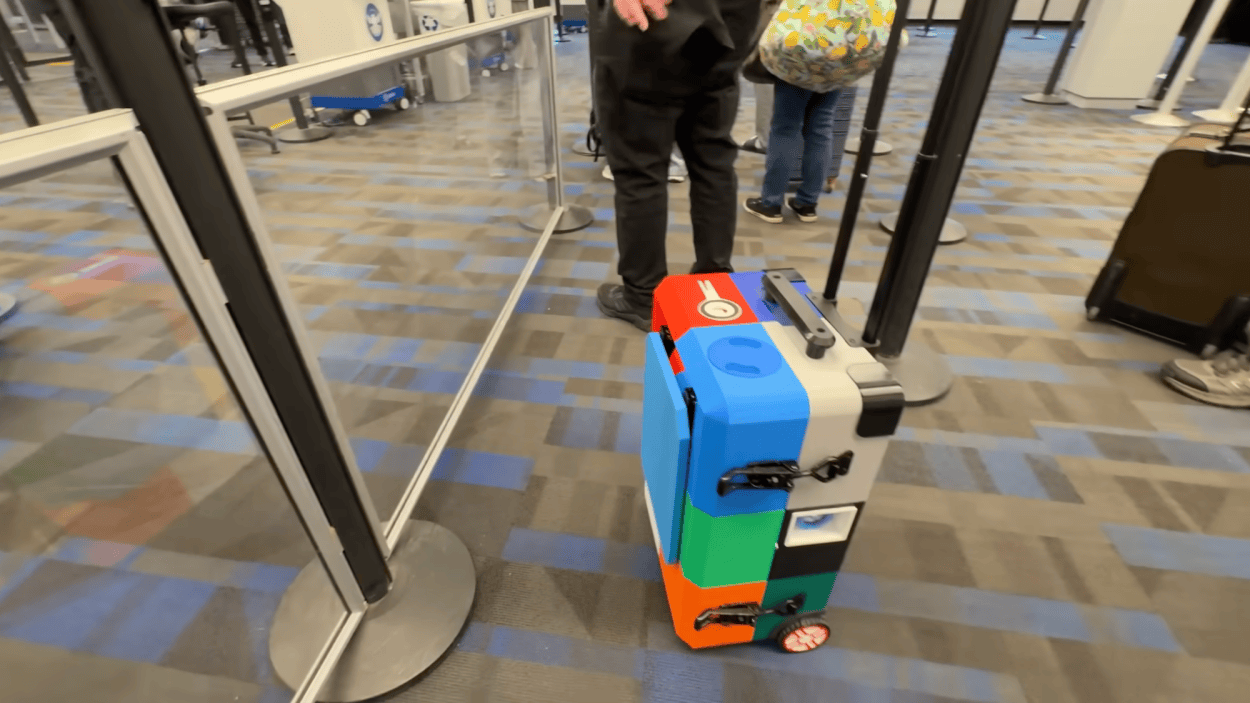 3D-printed suitcase includes foldout table, cup holder, and a secret ...