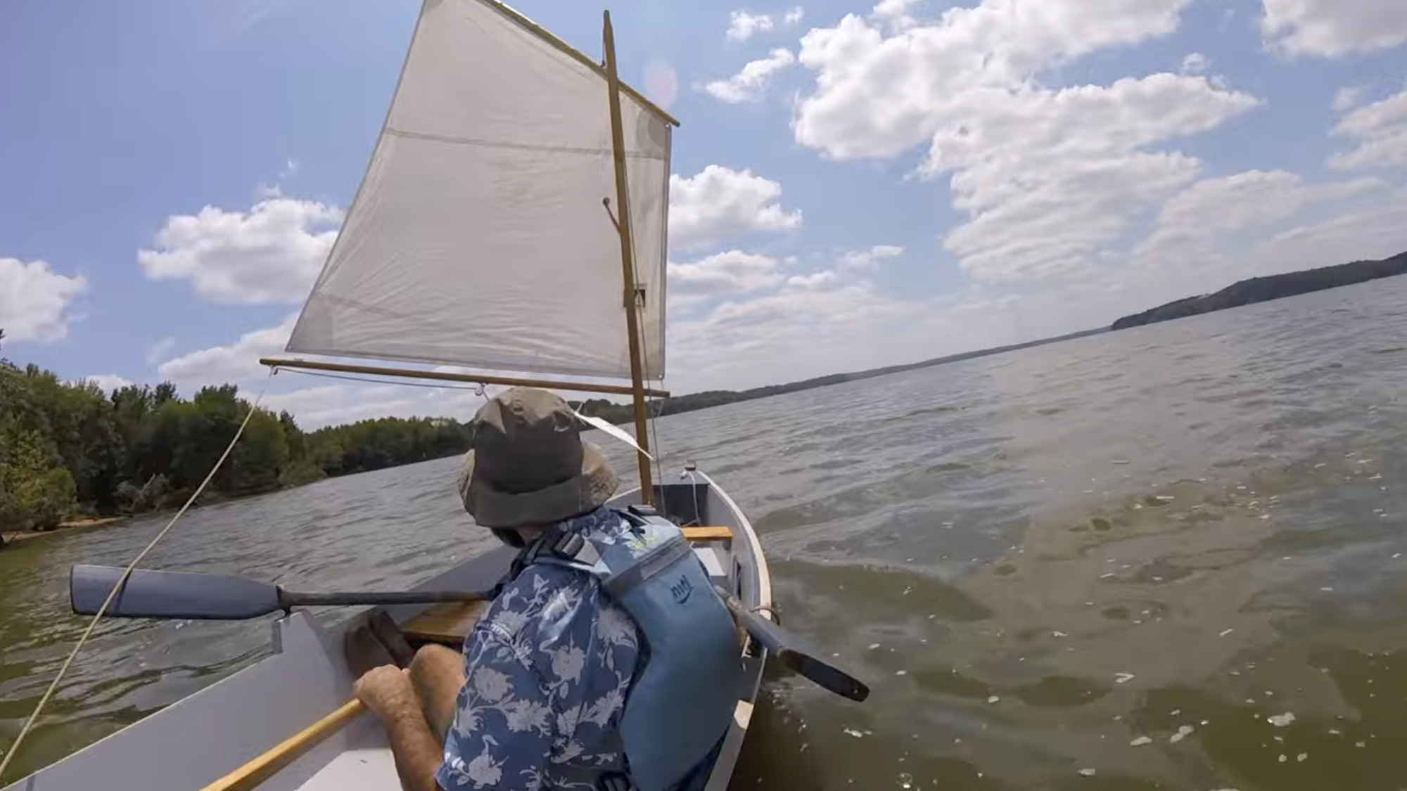 a man sails a homemade boat