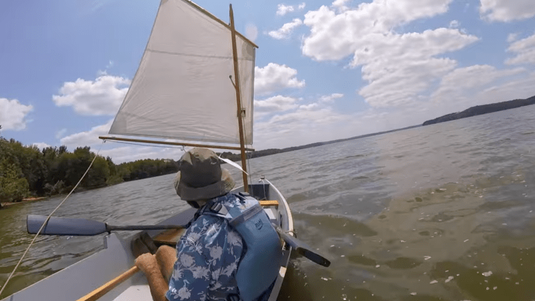a man sails a homemade boat