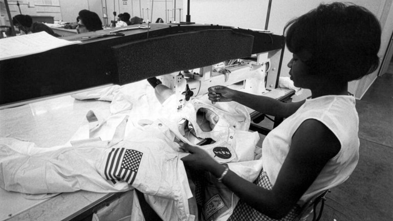 Seamstress Jean Wilson applies finishing touches to one section of a spacesuit for NASA's Apollo lunar missions on a long-arm sewing machine, built especially for manufacturing the spacesuits.