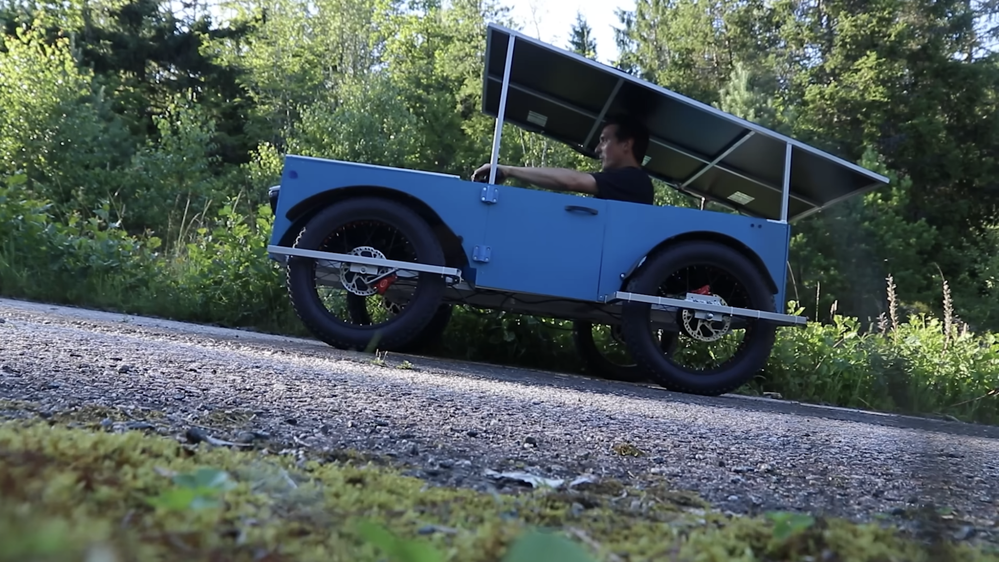 Blue solar power car driving up hill